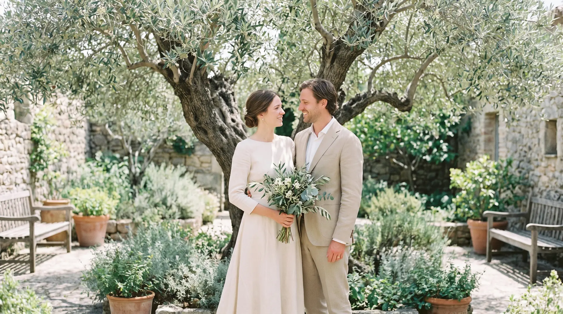 A couple in an olive-tree courtyard